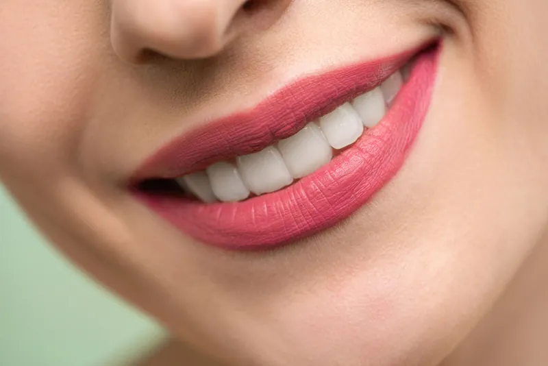 A relaxed, natural smile in daylight